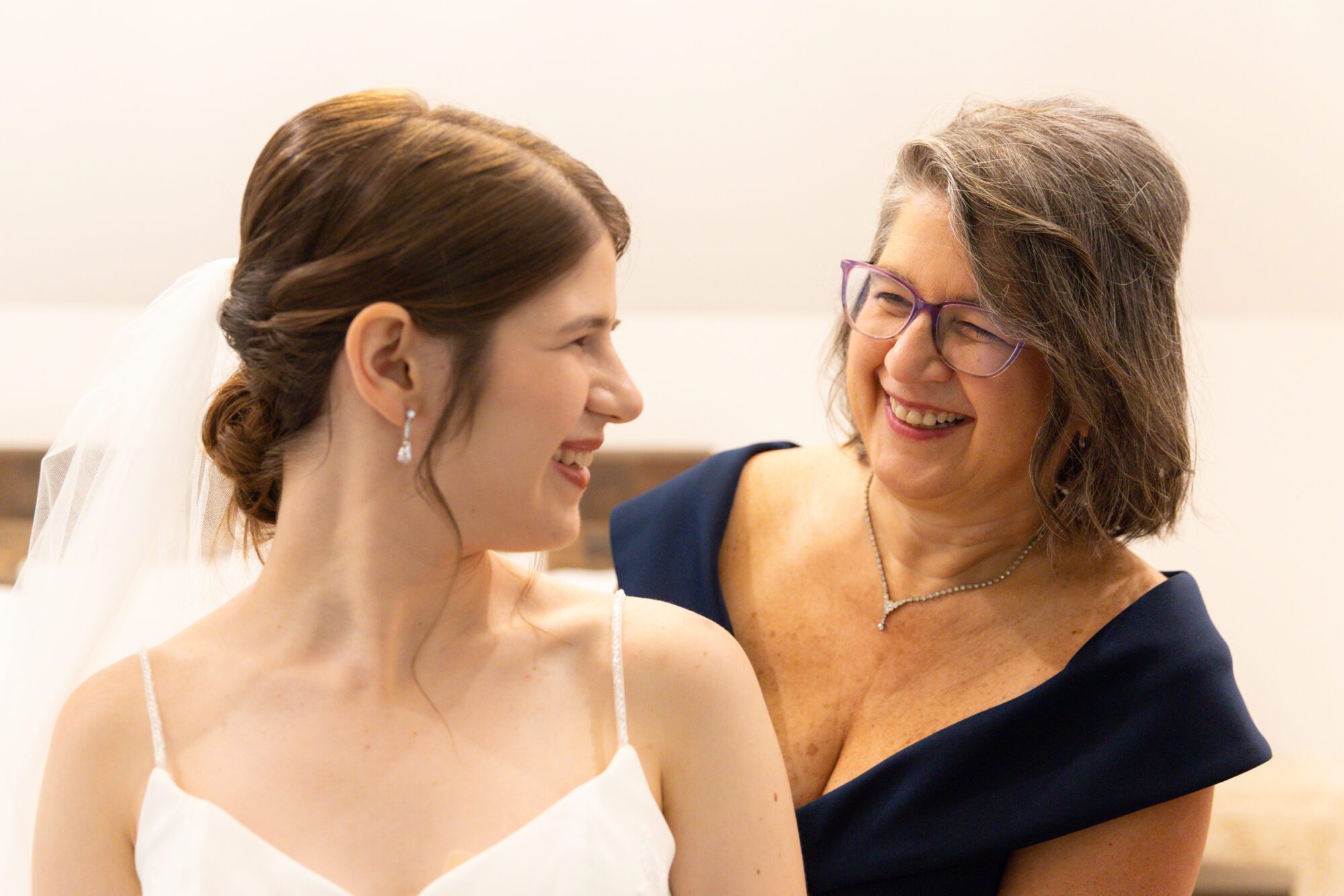 Jewish bride and groom's getting ready photos at Standing Rock Farms. Mom helping bride into dress.
