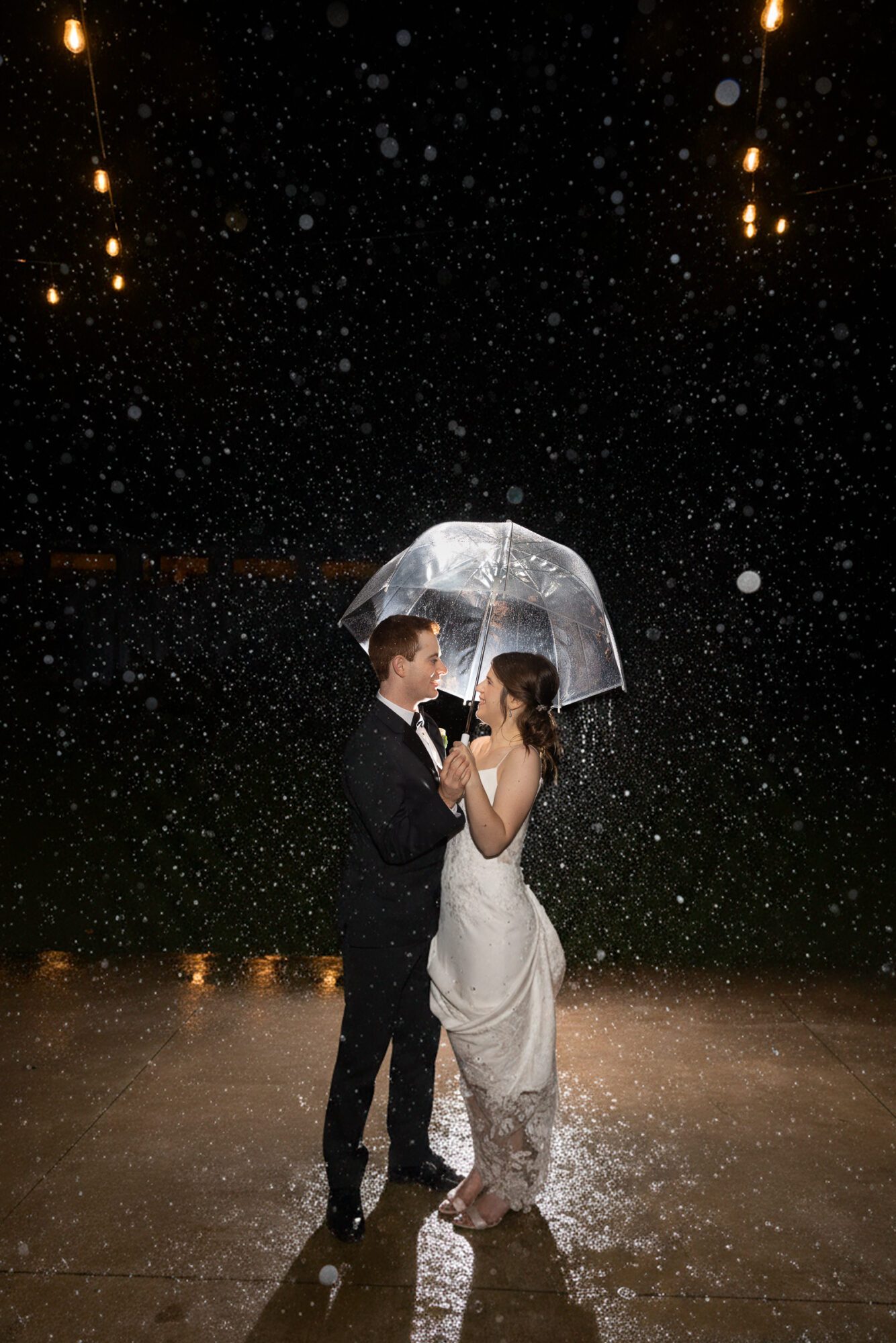 Jewish Bride and Groom under umbrella in the rain on their wedding day.