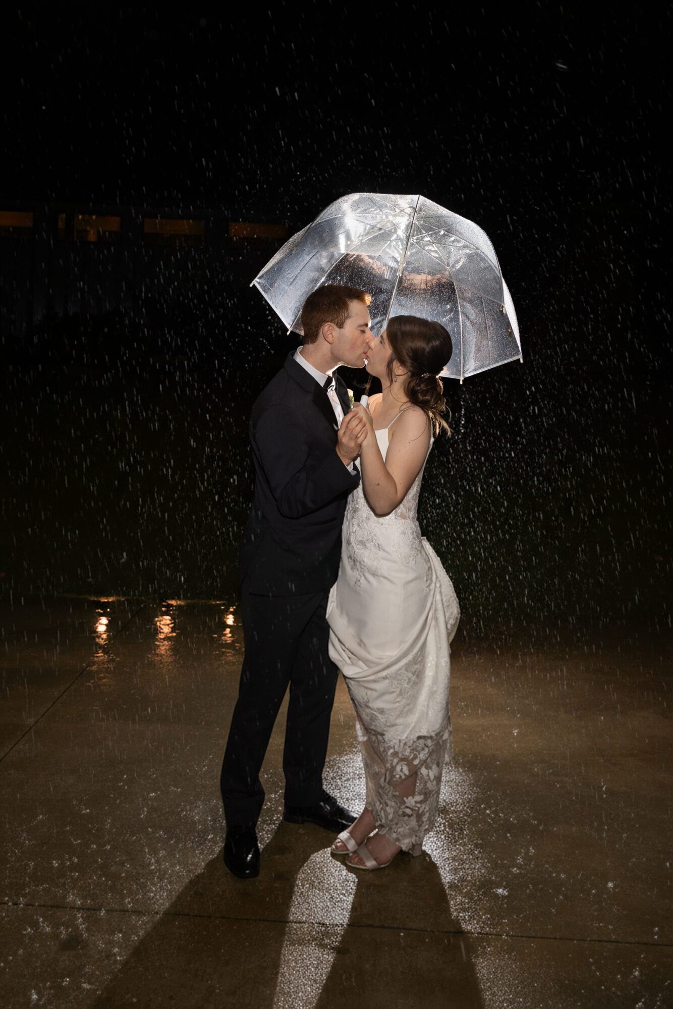 Jewish Bride and Groom under umbrella in the rain on their wedding day.