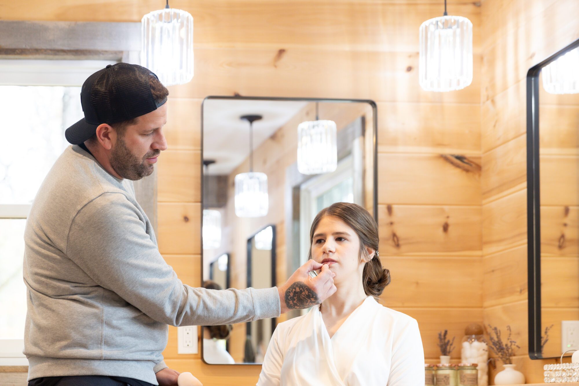 Jewish bride and groom's getting ready photos at Standing Rock Farms. Final makeup touches